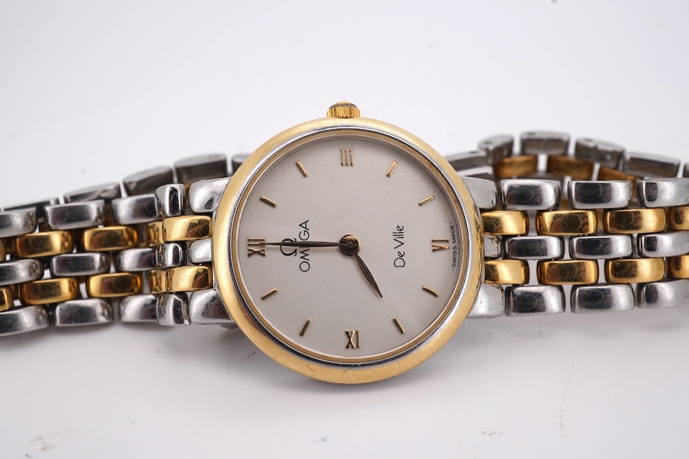 A lady's steel and gold plated Omega de Ville quartz wrist watch, with baton and quarterly Roman numerals, on a stainless steel and gold plated bracelet, case diameter 24mm, no box or papers. Condition - poor to fair